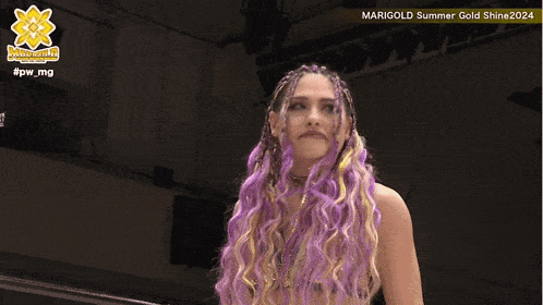a woman with purple hair and braids stands in front of a sign that says marigold