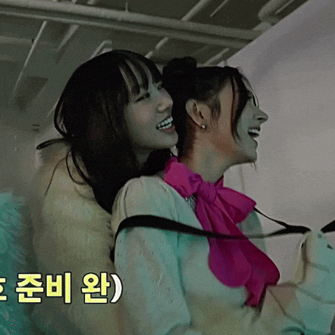 a woman in a pink bow tie is sitting on another woman 's back