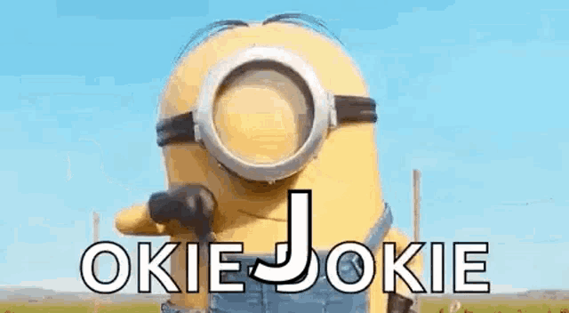 a minion from the movie despicable me is talking on a cell phone while wearing goggles .