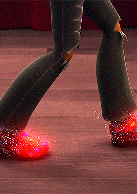 a cartoon character is walking on a wooden floor with glowing red shoes
