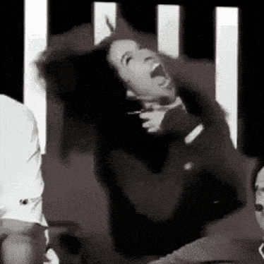a black and white photo of a woman screaming with her mouth open