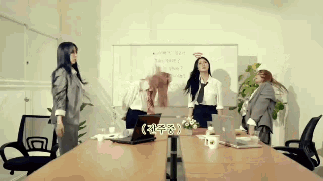 a group of women are standing around a conference table with a white board behind them that says wifi