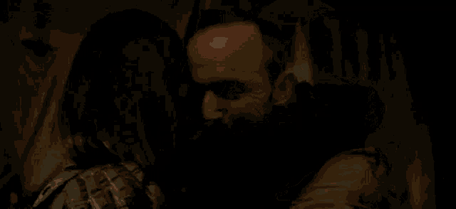 a man and woman are hugging each other in a dark room .