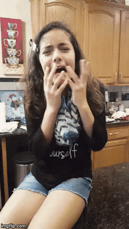 a girl wearing a shirt that says yourself is making a face
