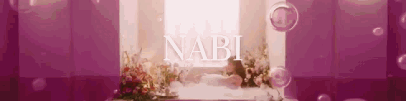 the word nabi is on a pink background with flowers and soap bubbles .