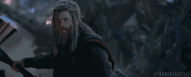 a man with dreadlocks is holding a hammer with lightning coming out of it ..