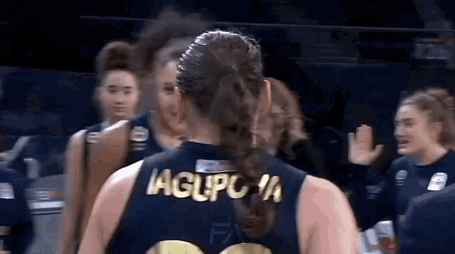 a female basketball player wearing a jersey that says aglpc