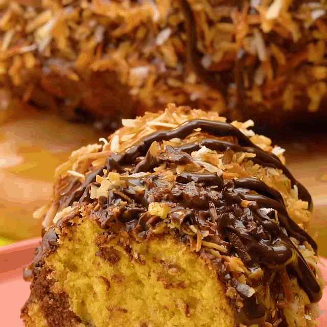 a close up of a piece of cake with chocolate and coconut