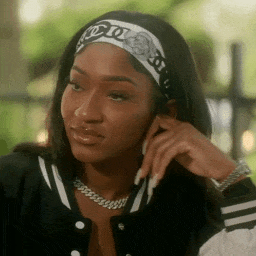 a woman wearing a headband is talking on a cell phone .
