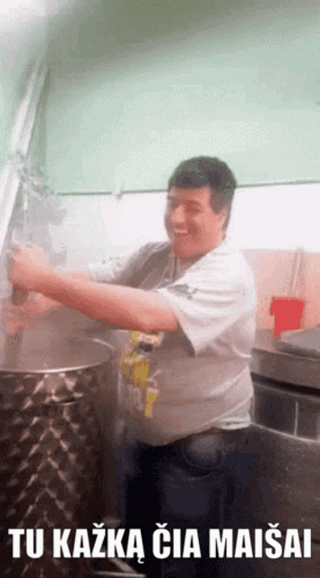 a man in a kitchen with the words tu kazka cia maisai written below him