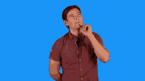 a man in a red shirt is thinking about something while looking up .