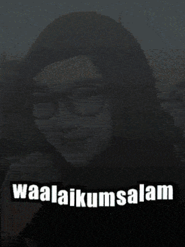 a woman wearing glasses and a hijab with the words waalaikumsalam below her
