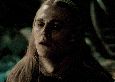 a close up of a man 's face with long hair