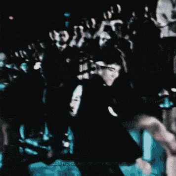 a man in a black shirt is giving the middle finger