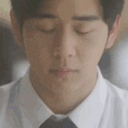a close up of a man 's face with his eyes closed and a white shirt and tie .
