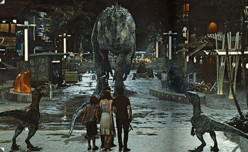a group of people standing in front of a large dinosaur in a park .