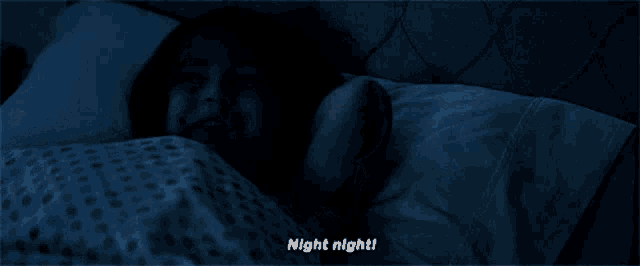 a woman is laying in bed with the words night night written on the bottom