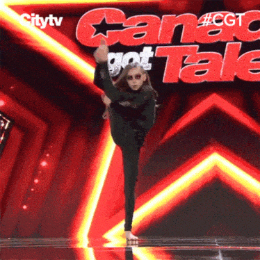 a girl is doing a split on stage in front of a sign that says citytv
