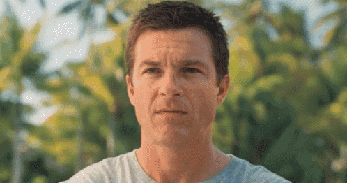a close up of a man 's face with a blurred background