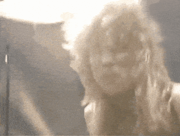 a close up of a woman 's face with blonde hair