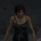 a woman in a black tank top is standing in a dark room in a video game .