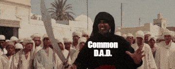 a man with a sword is wearing a shirt that says " common dad "