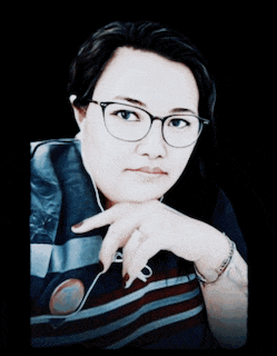 a woman wearing glasses and a shirt that says zkee on it