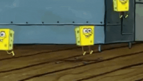 three spongebob squarepants cubes are dancing together on a wooden floor .