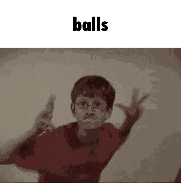 a boy with glasses is making a peace sign with his hands and the word balls is above him .