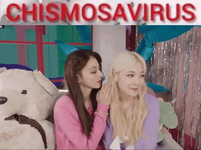 two girls sitting next to each other with a sign that says chismosavirus