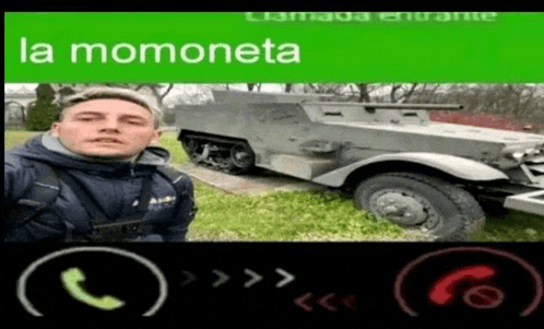 a man taking a selfie next to a military vehicle with the words la momoneta on the top