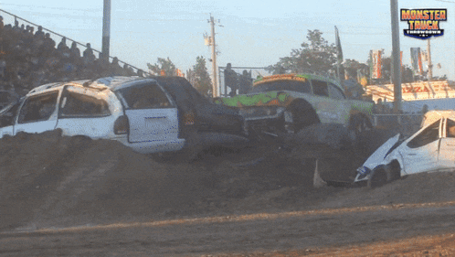 a monster truck race is taking place on a dirt road