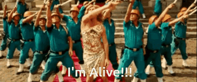 a woman in a gold dress is surrounded by police officers and says i 'm alive