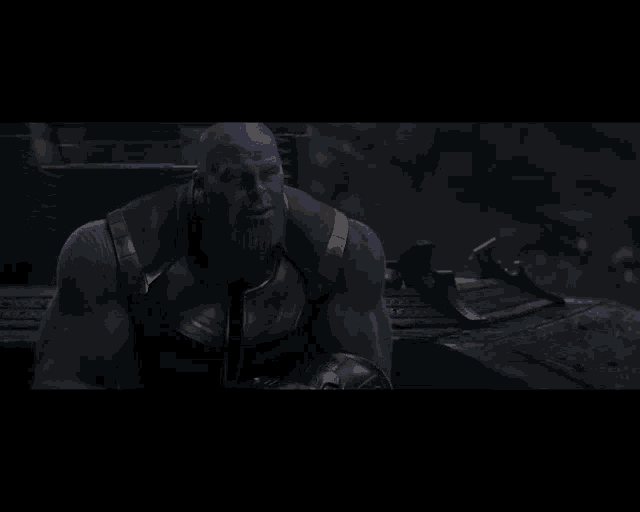 thanos in a dark room with a beard