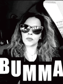 a woman wearing sunglasses is sitting in a car with the word bumma in the corner