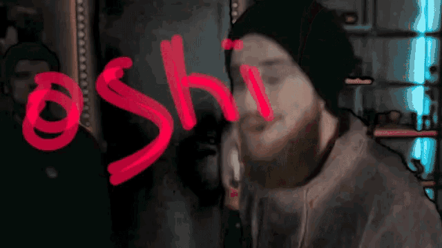 a man with a beard has the word ashi written in red