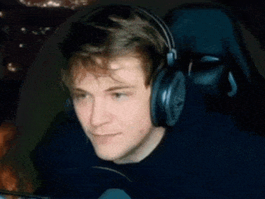 a man wearing headphones is sitting in a chair .