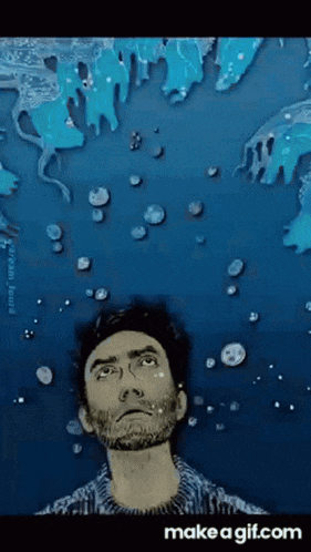 a man with a beard is looking up at the sky with bubbles coming out of it