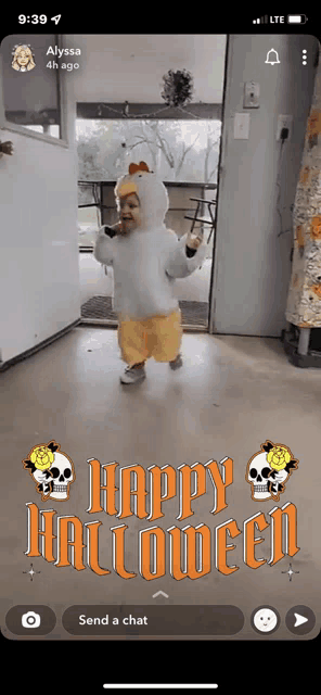 a phone screen shows a baby in a chicken costume