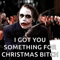 the joker from the movie the dark knight is holding a knife and says `` i got you something for christmas bitch ''
