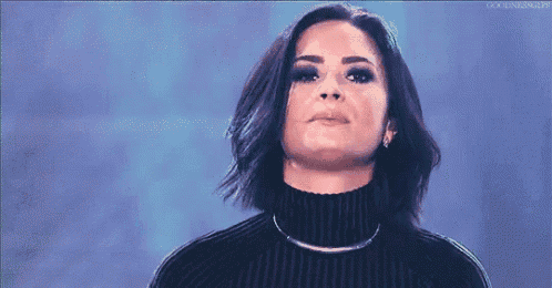 a woman is wearing a black turtleneck sweater and a choker necklace .