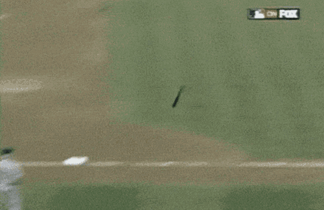 a man in a baseball uniform is doing a handstand