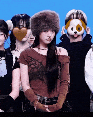 a woman wearing a fur hat and gloves stands in front of a group of people