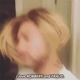 a woman is making a funny face and saying i love robbery and fraud