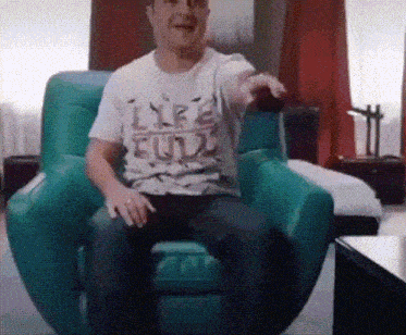 a man is sitting in a chair wearing a life full shirt