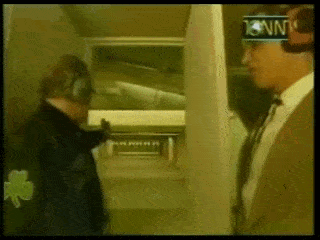 a man wearing headphones is talking to another man in a room with cnn written on the corner