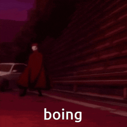 a white car is driving down a road with the word boing written on the bottom