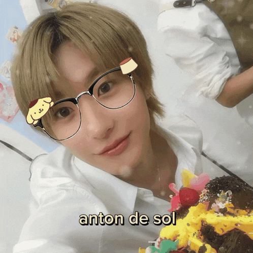a young man wearing glasses has anton de sol written on his forehead
