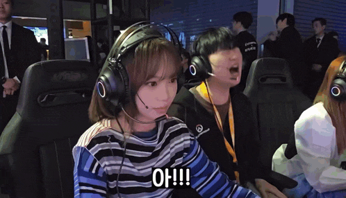 a girl wearing headphones says " oh !!! " in front of a man