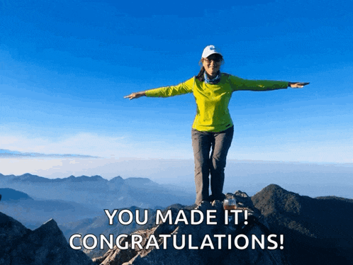 a woman standing on top of a mountain with congratulations written below her